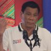 Philippine President Rodrigo Duterte raises a middle finger thrust out in an obscene gesture as he speaks before local government officials in Davao